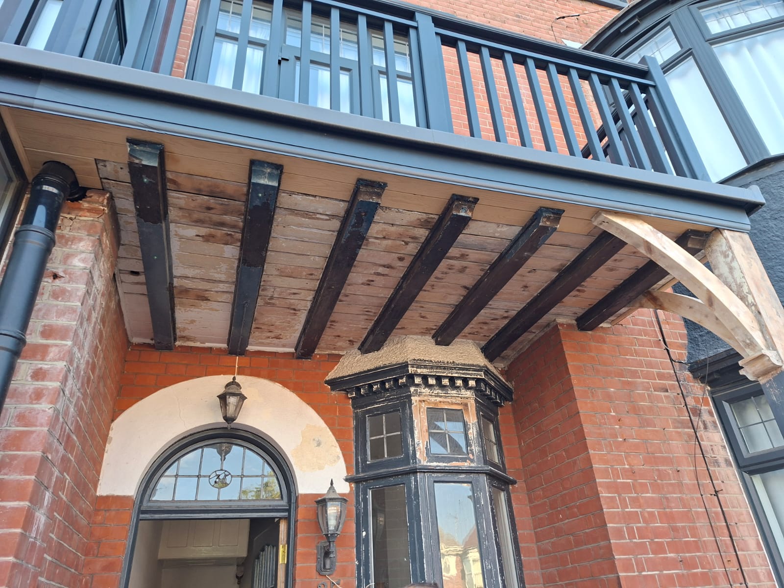 Balcony soffit stripped back to the original timber joists before redecoration
