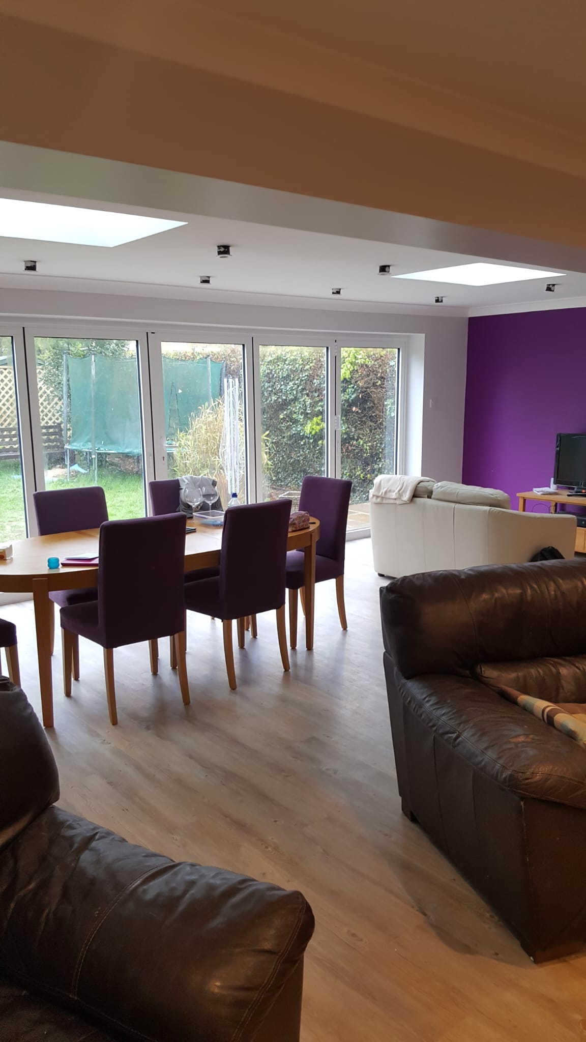 Painted living and dining room with a bold feature wall