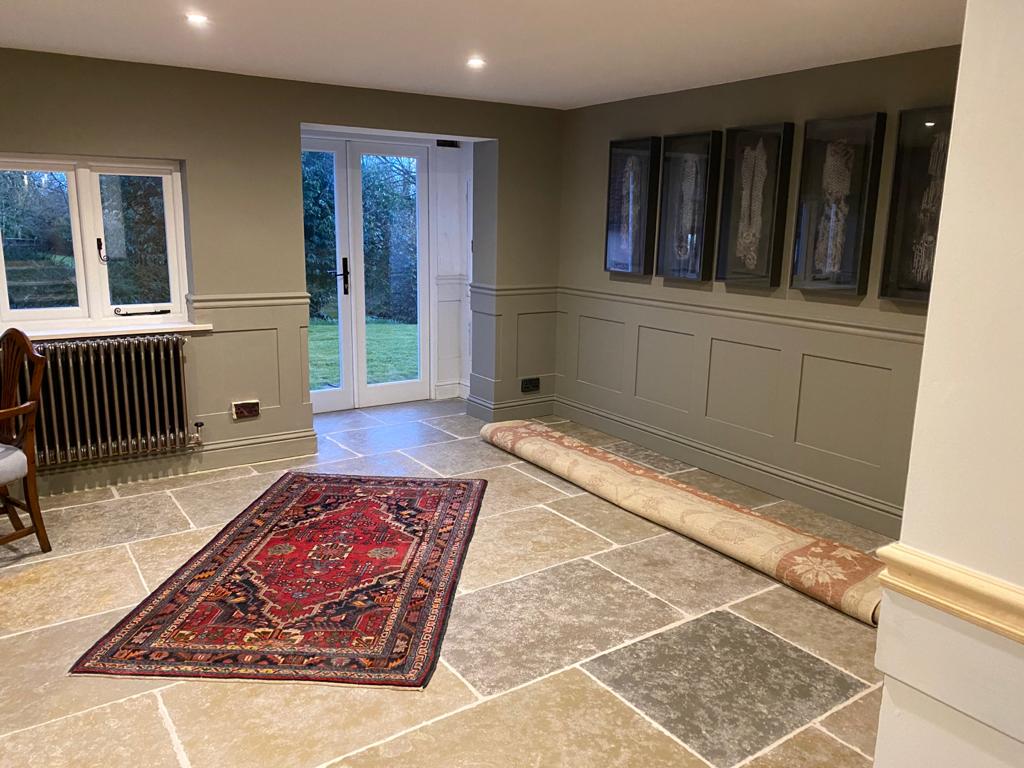 Hallway with sage panelling, stone floor and French doors